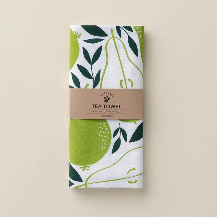 Tea towel with green and leaf pattern on a beige background