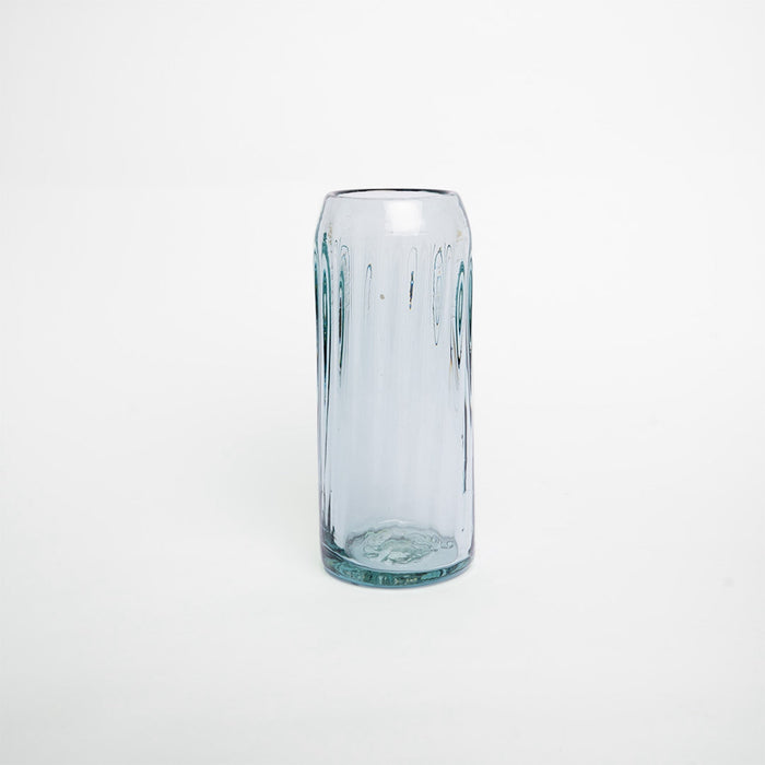 A clear glass with a solid pattern and no visible contents.