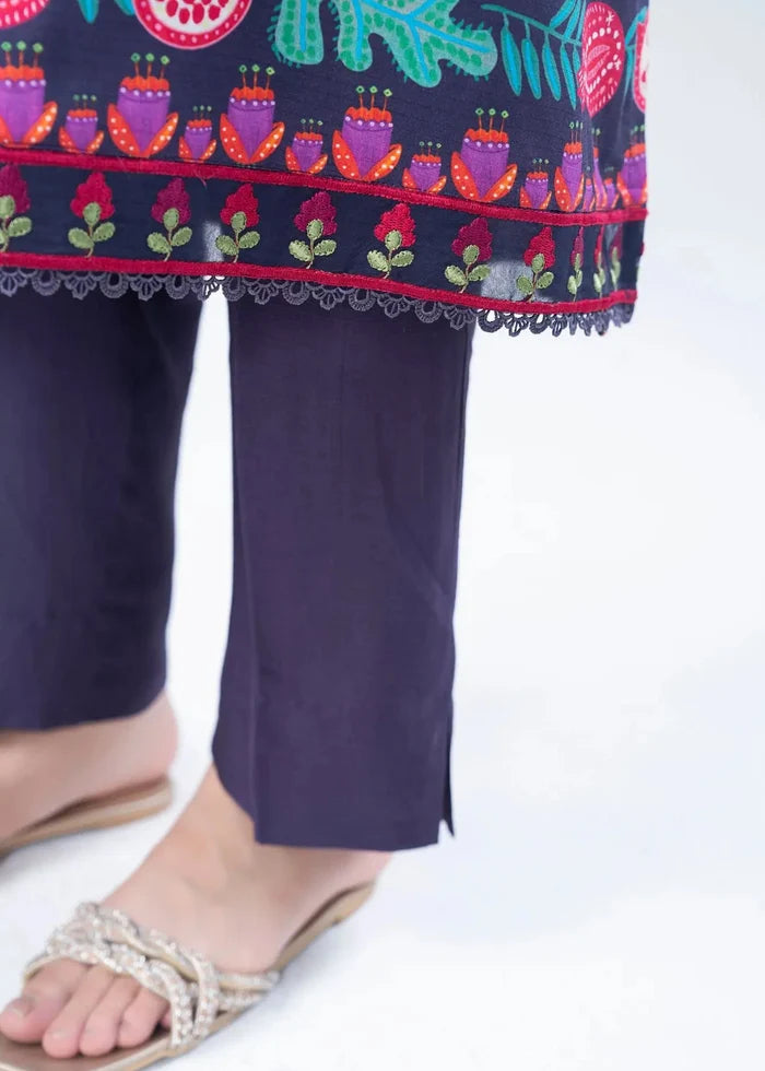Women's winter suit detail: printed kurta hem trim over dark navy pants