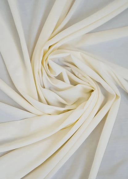 Cream wash-and-wear fabric with soft folds, close-up
