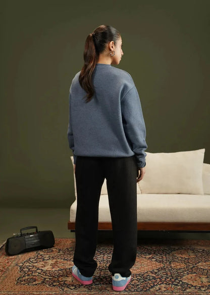 Blue knit crewneck sweatshirt, back view, long sleeves with ribbed cuffs