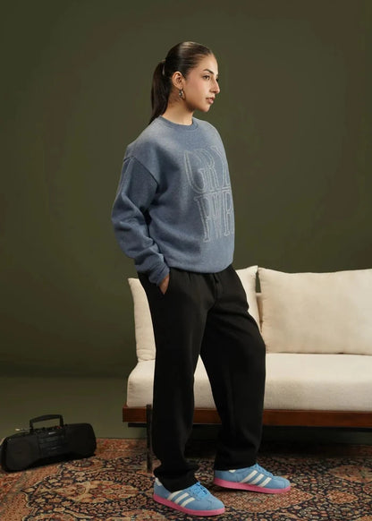 Blue knit crewneck sweatshirt with 'GRL' logo, side view, long sleeves