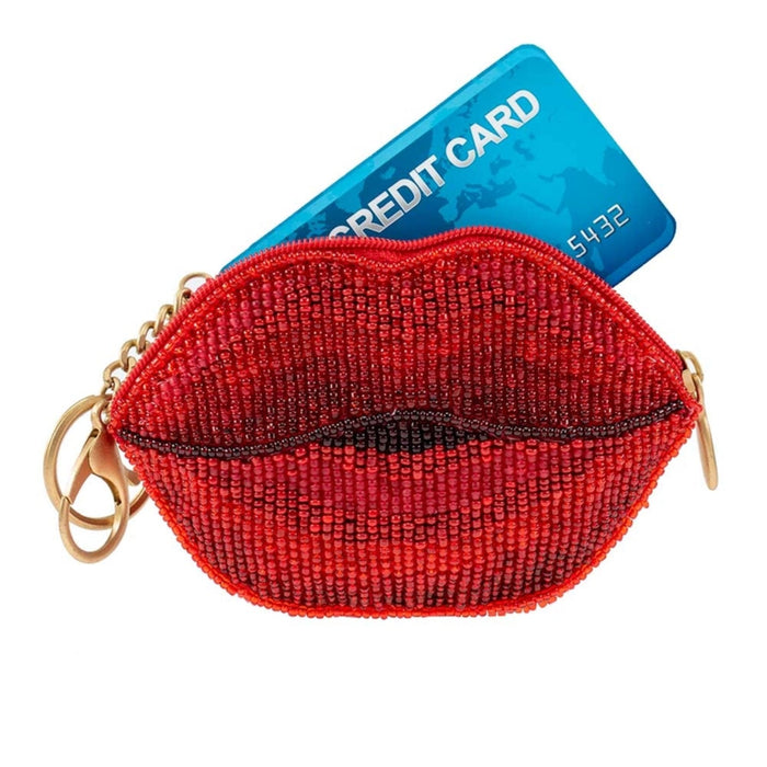 Red lip-shaped coin purse key chain with a blue credit card on a white background